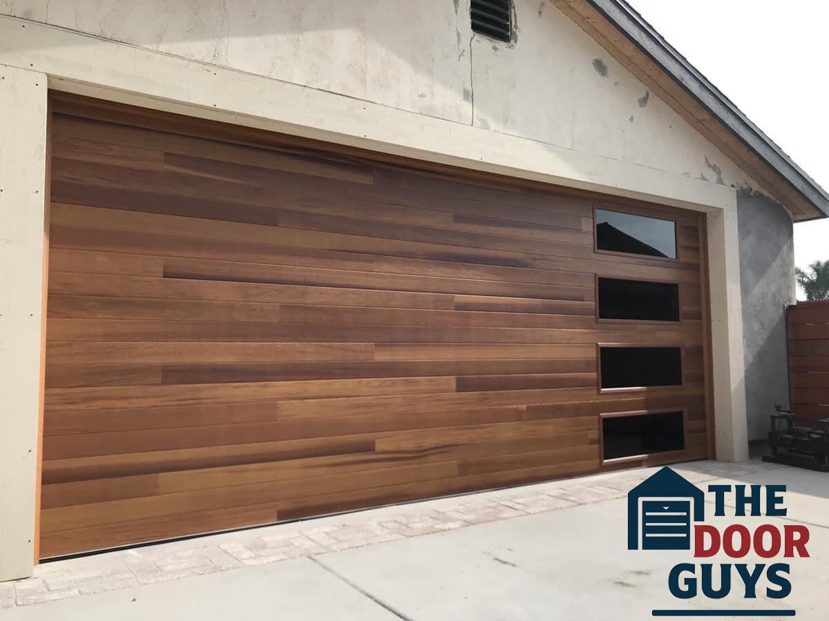 Custom brown garage door with matching side windows, installed by The Door Guys.